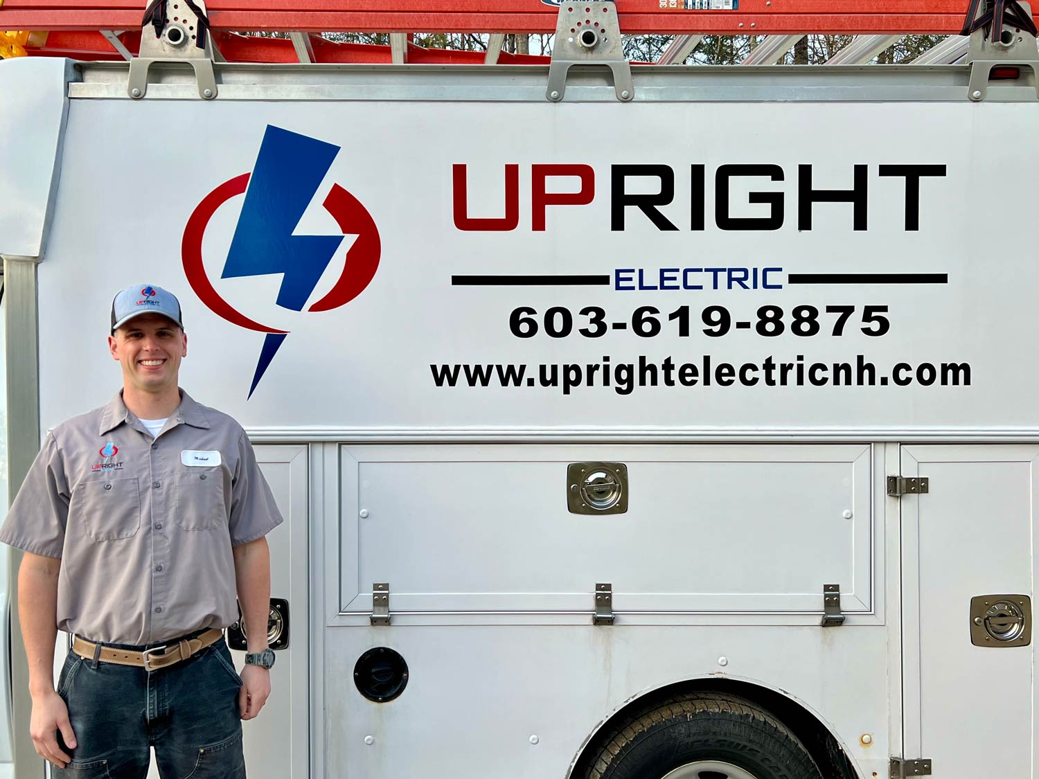 Michael Stacey of Upright Electric standing beside the branded service truck