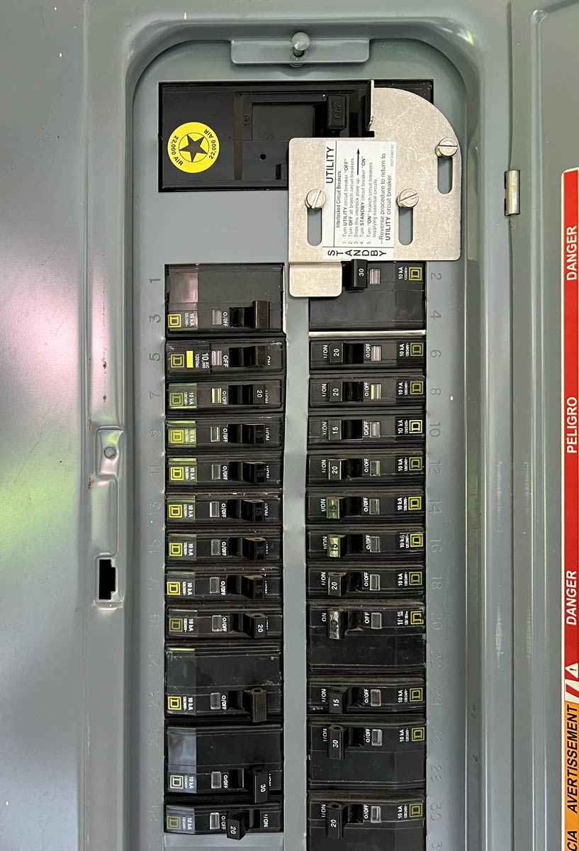 Generator interlock kit mounted on a residential electrical panel