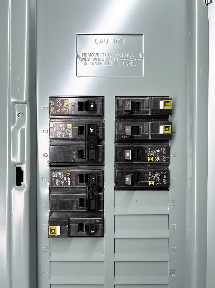Open residential electrical panel showing two columns of labeled circuit breakers