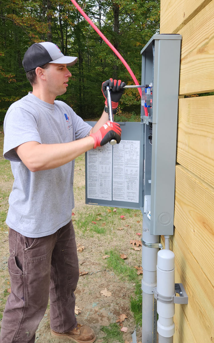 Electrician torquing connections in an outdoor meter and main panel