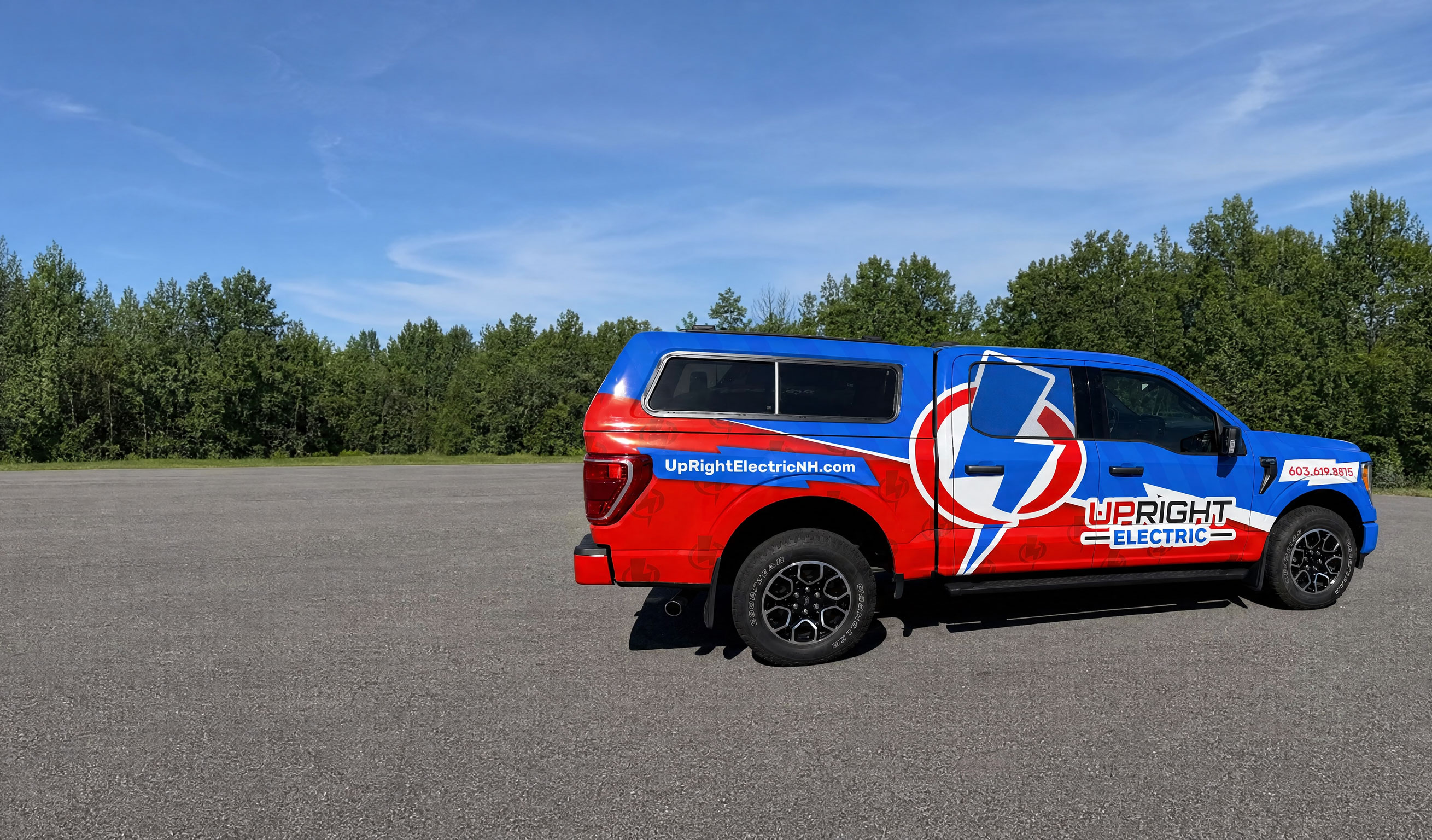 Upright Electric service truck wrapped in blue and red branding, parked in New Hampshire